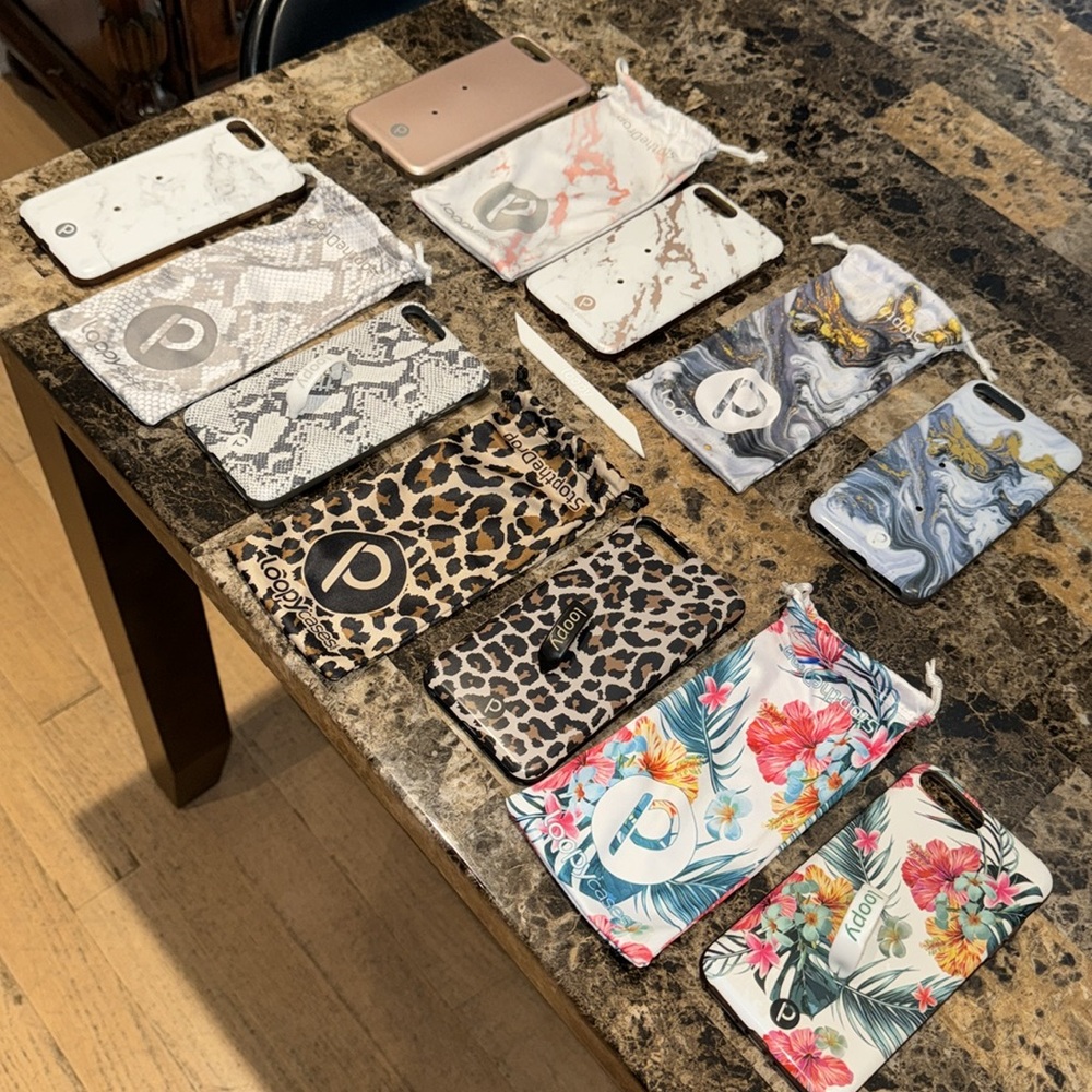 A lot of seven iPhone 8 Plus loopy cases, five loopy dust bags, one extra loop